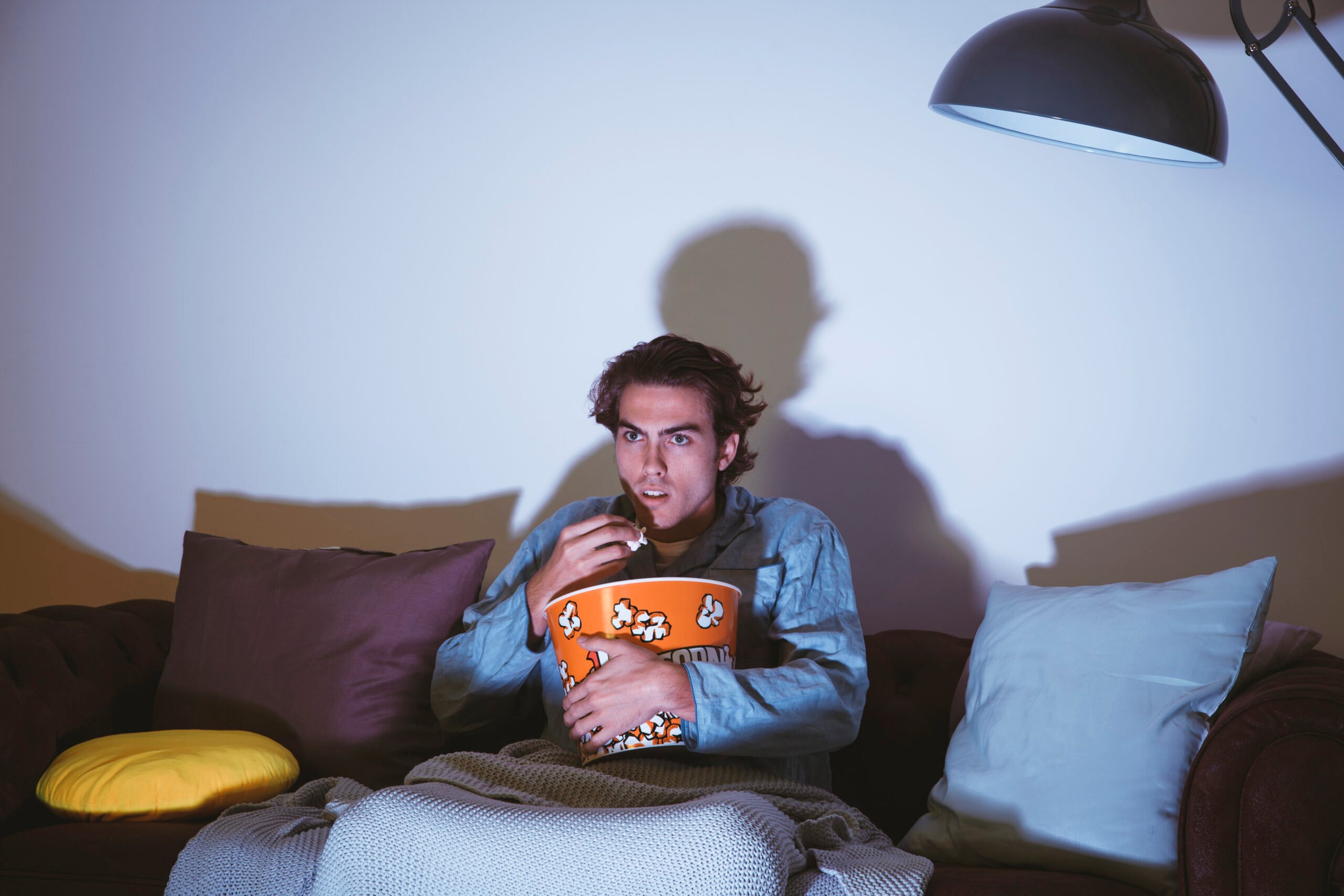 man-watching-movie-eating-popcorn